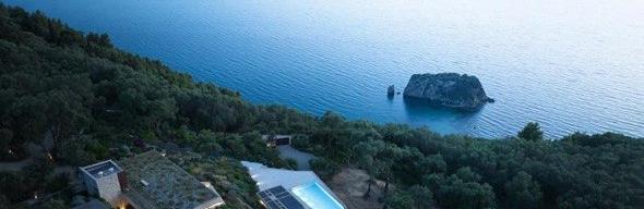 Aerial dusk view of villa, pool and coastline